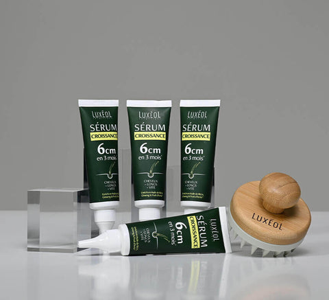 Product lineup with Growth Serum and protocol set on acrylic blocks.