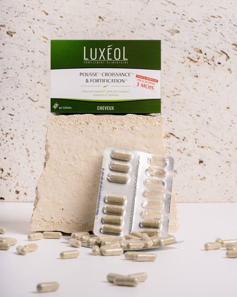 Luxéol hair growth and strengthening supplement packaging with capsules on a textured surface