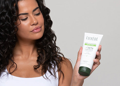 women holding shampoo in the hands 